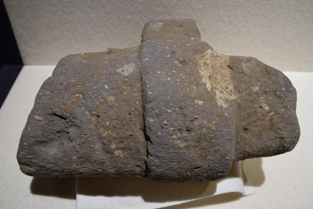 左側が長い横長の石の上に帯状に短い石が乗っているような形をした石刀の写真